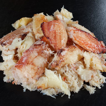 A photograph of chilean crab meat with claw and leg meat over body meat.