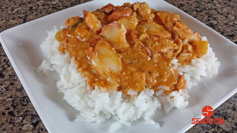 A photograph of Chilean crab meat in red curry sauce over rice.